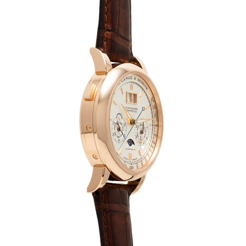 Rose gold watch with white dial, chronograph subdials, moon phase indicator, and brown crocodile leather strap.
