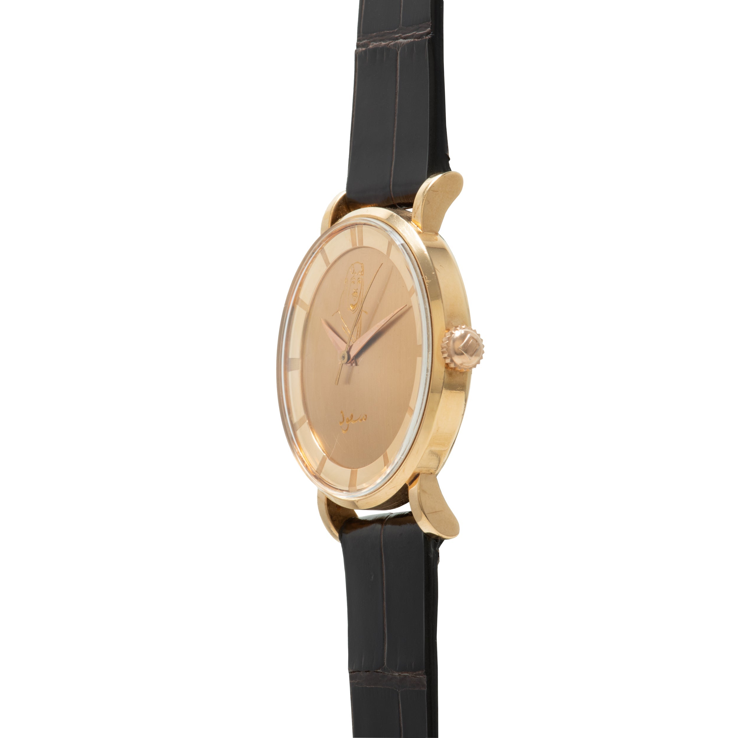 Gold-toned oval watch with champagne dial, Arabic numerals, and black leather strap.
