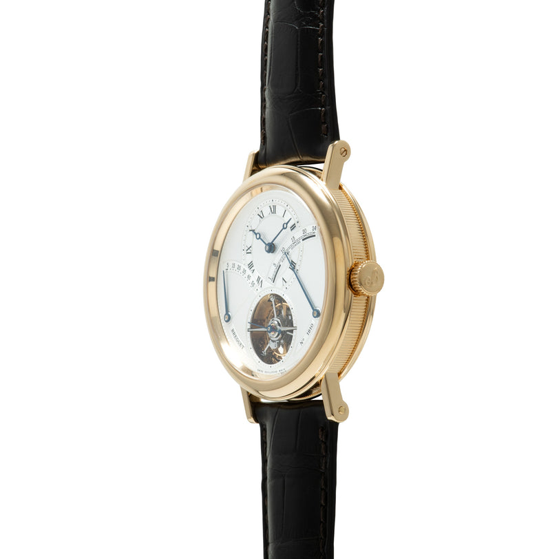 Gold-toned oval watch with white dial, Roman numerals, visible tourbillon escapement at bottom, and black crocodile leather s