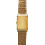 Gold-tone rectangular watch with tan crocodile leather strap and crown on side.