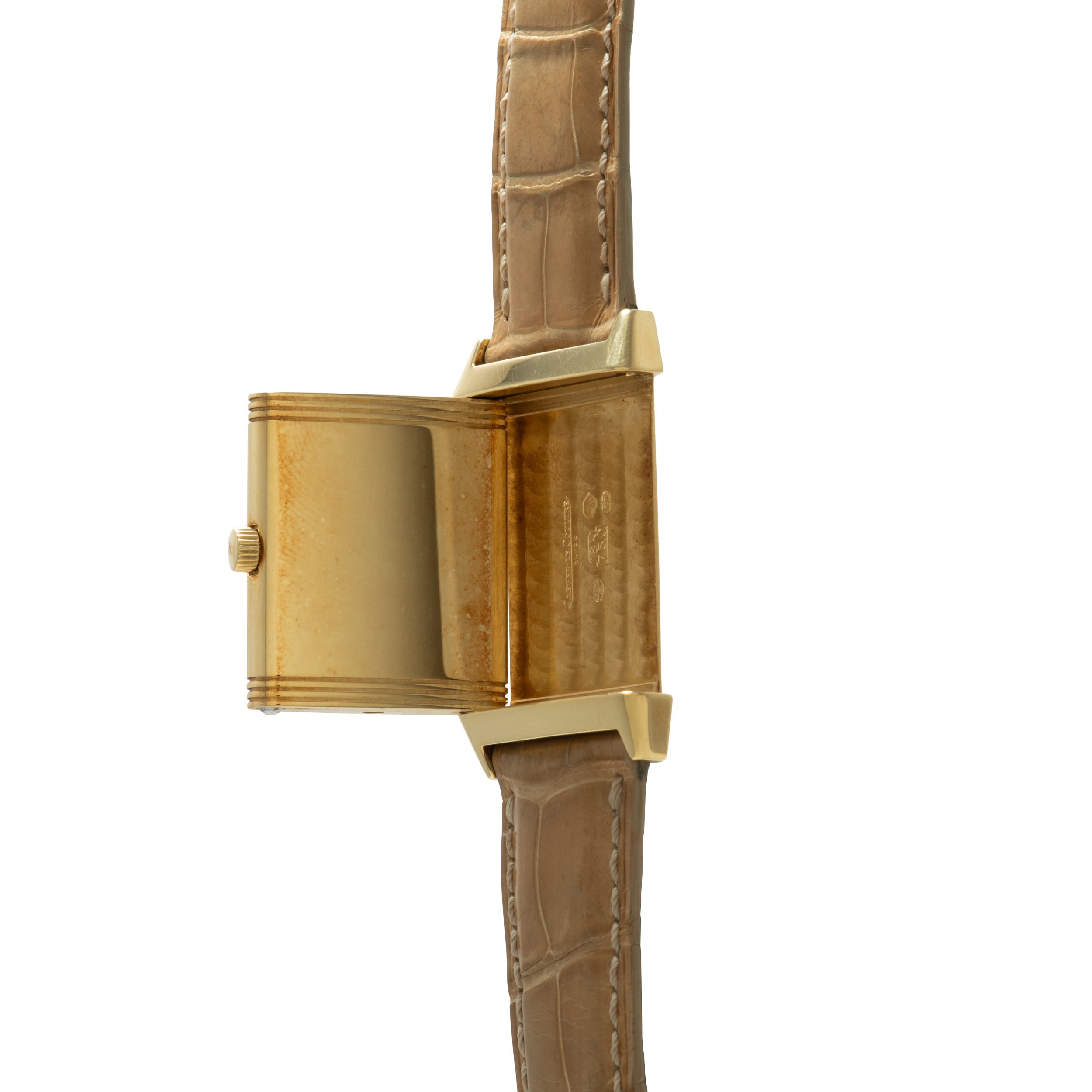 Gold-tone rectangular watch with reversible case, tan crocodile leather strap, and crown on side of case.