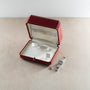 Cartier Panthere diamond watch with matching ring displayed in open burgundy leather box.