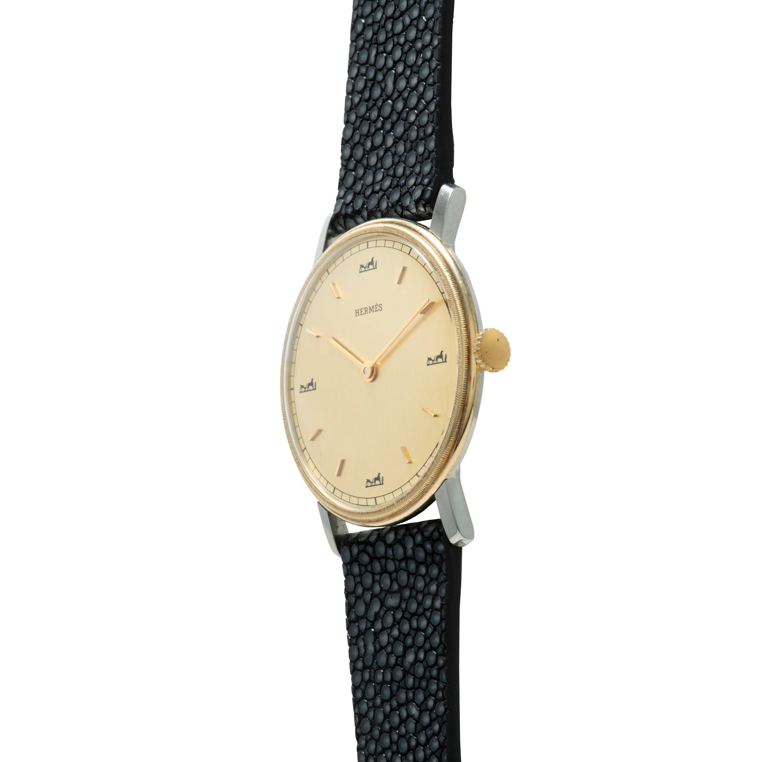 Hermès wristwatch with cream dial, gold-tone case, gold crown, and black textured leather strap.