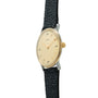 Hermès wristwatch with cream dial, gold-tone case, gold crown, and black textured leather strap.