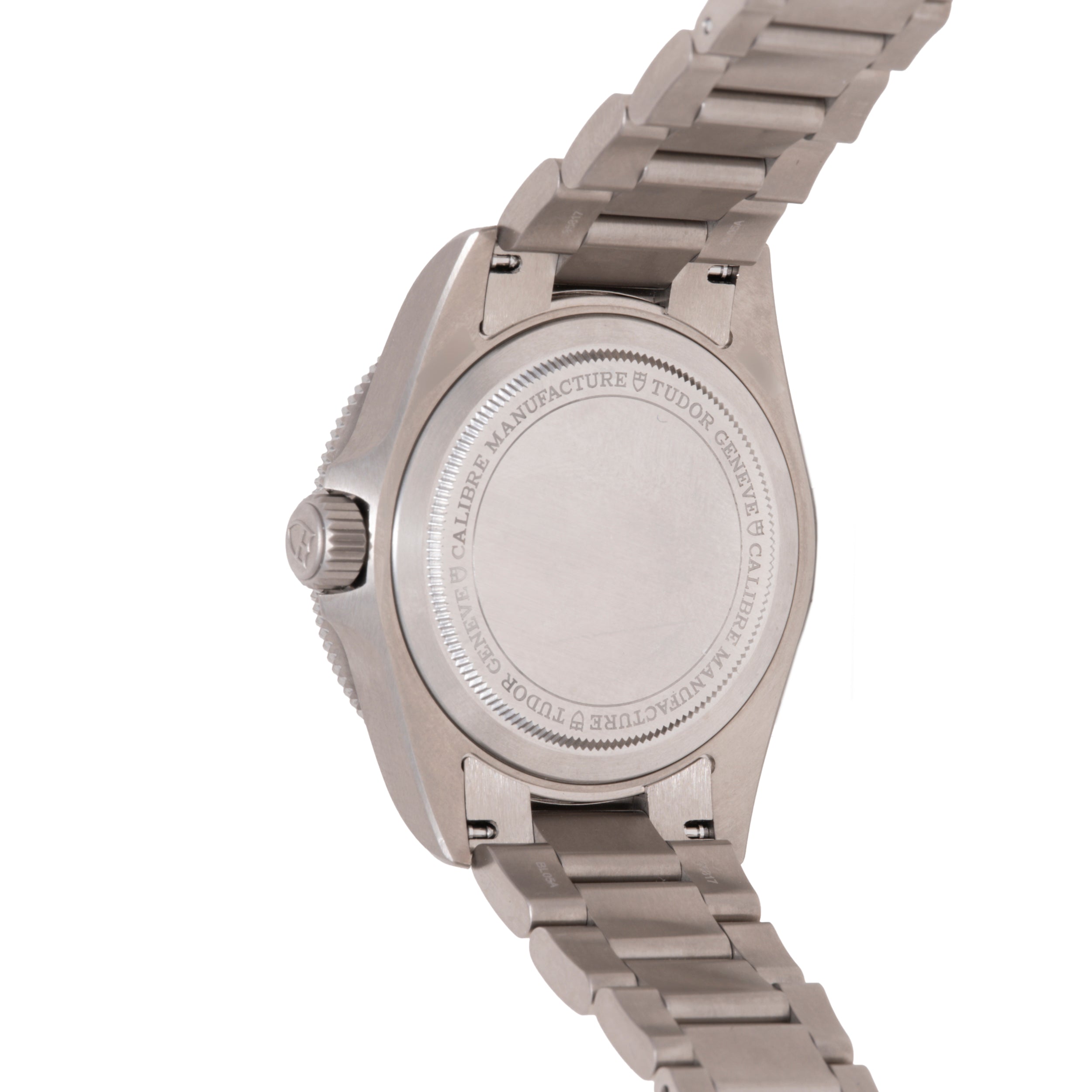 Stainless steel Tudor Pelagos 39 watch with metal bracelet shown from the side, displaying the caseback with engraved text.