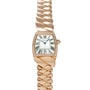 Rose gold watch with tonneau-shaped dial, Roman numerals, diamond bezel, and twisted rose gold bracelet.