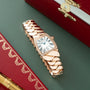 Rose gold watch with square white dial, Roman numerals, diamond bezel, and articulated link bracelet on burgundy case.