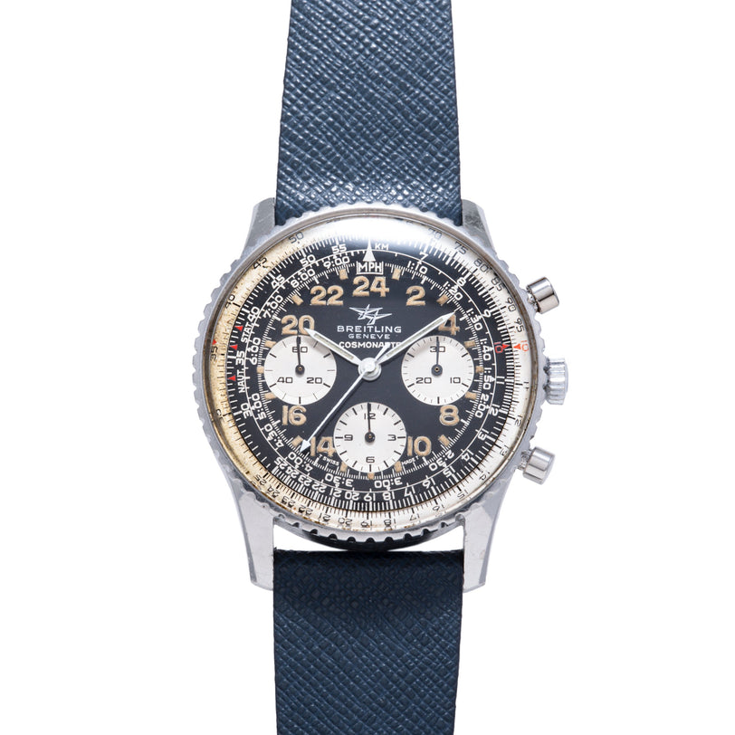 Breitling Cosmonaute chronograph watch with black dial, white subdials, 24-hour numerals, and dark blue fabric strap.