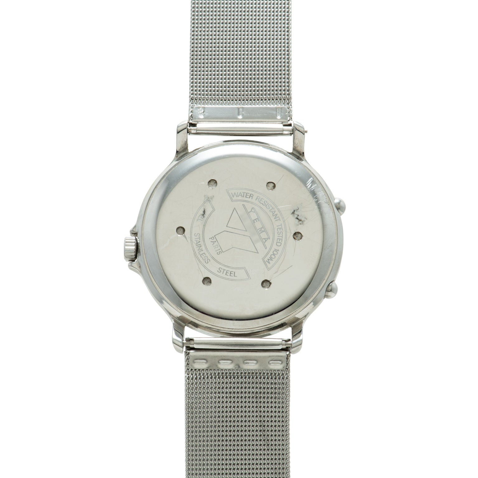Silver stainless steel watch with mesh band and cream dial showing ISS emblem on caseback.