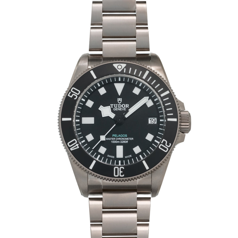 Tudor Pelagos dive watch with black dial, white hour markers, date window, and stainless steel bracelet.