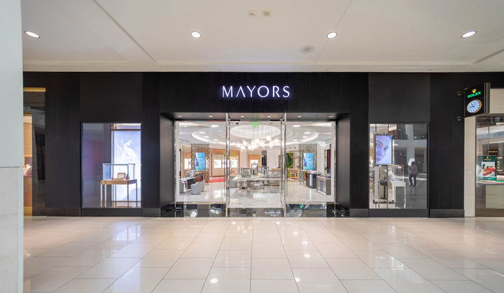 Front view of a MAYORS jewelry store in a shopping mall with glass doors and displays inside.