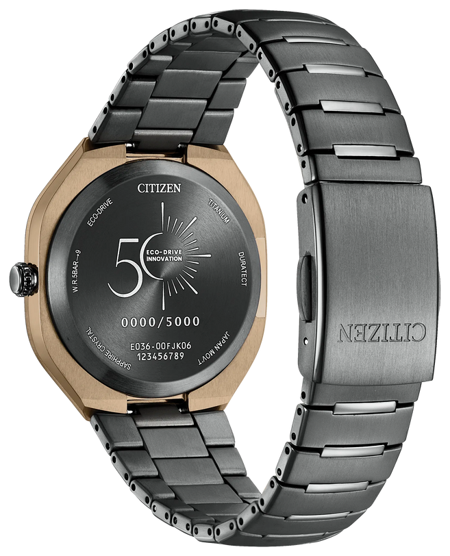 Black titanium bracelet watch with rose gold case, black dial displaying "50 Eco-Drive Innovation" text, and link band.