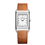 The Jaeger-LeCoultre Reverso Tribute Monoface is a rectangular silver watch with a white dial, black hour markers, and an interchangeable brown leather strap. The minimalist design features the Jaeger-LeCoultre name on the face.
