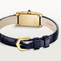 The Cartier Tank Américaine features a luxurious gold rectangular case, white dial with black Roman numerals, blue hands, and a dark blue leather strap—a true timeless classic.
