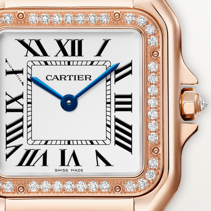 Rose gold Panthère de Cartier watch with white dial, blue hands, Roman numerals, and diamond-set bezel.