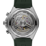 Stainless steel watch with visible mechanical movement through transparent caseback, green rubber strap, and chronograph push