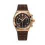 Rose gold chronograph watch with black dial, tachymeter bezel, and brown rubber strap.