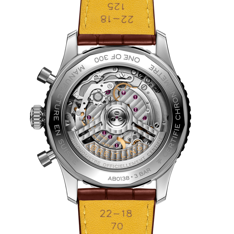 Watch with yellow leather strap and visible mechanical components on a white background