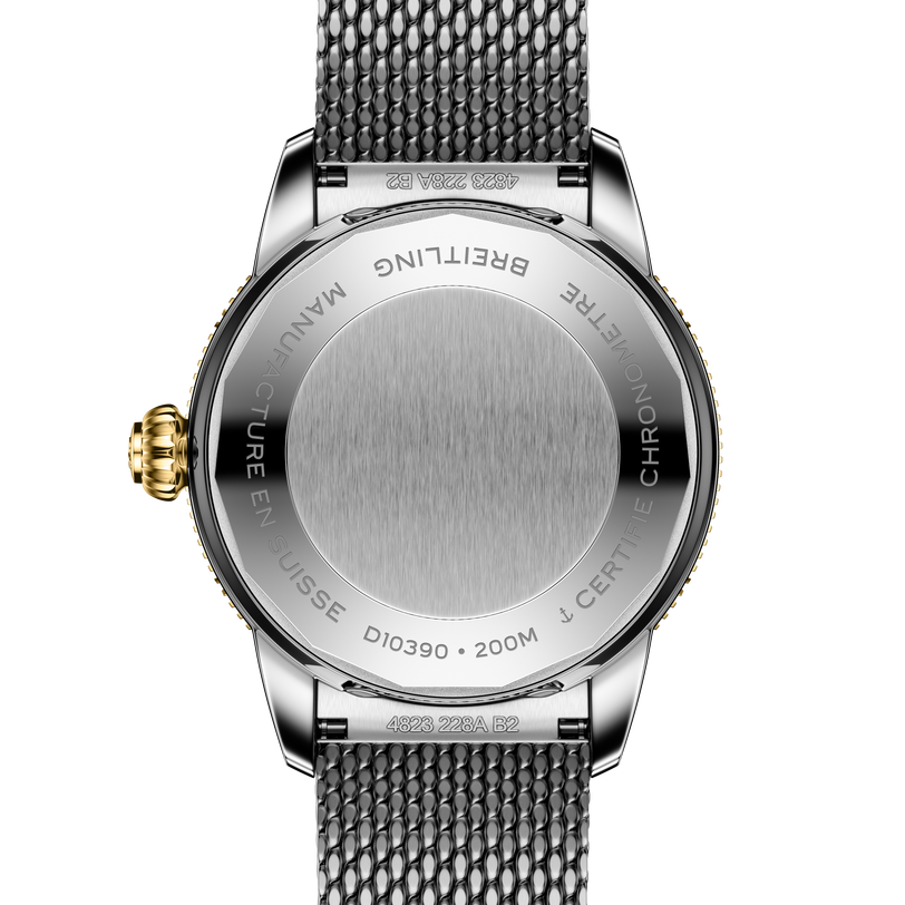 Stainless steel watch with white sunray brushed dial, gold crown, and steel mesh bracelet shown from back case view.