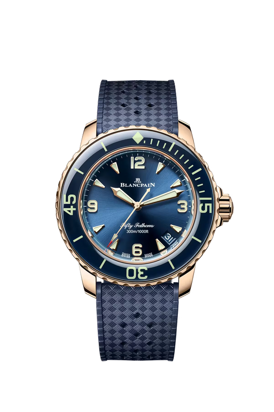 Blancpain Fifty Fathoms watch with rose gold case, sunburst blue dial, luminous hands, and dark blue rubber strap.