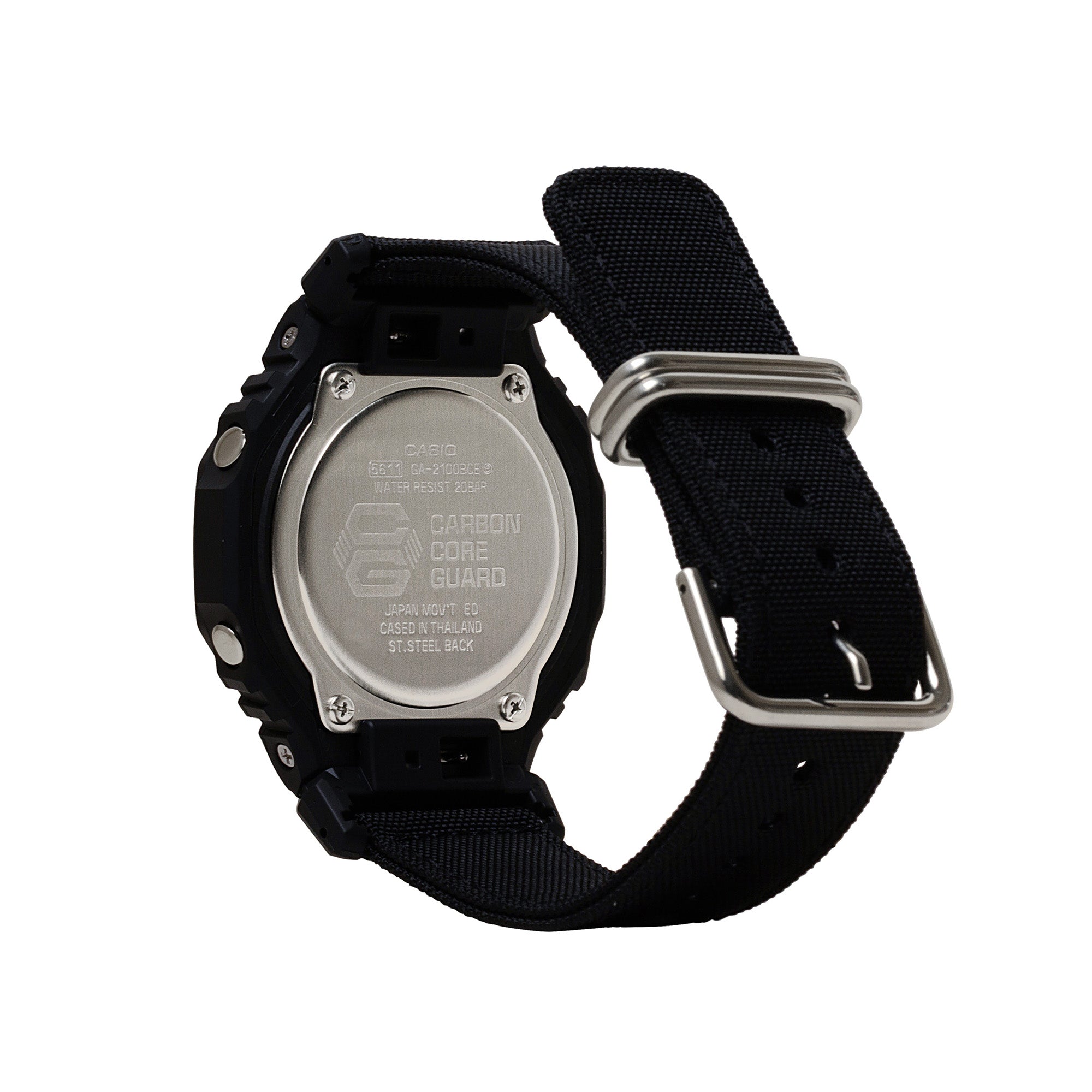 Black resin digital watch with black fabric strap, metal case back, and silver-tone hardware shown from rear angle.