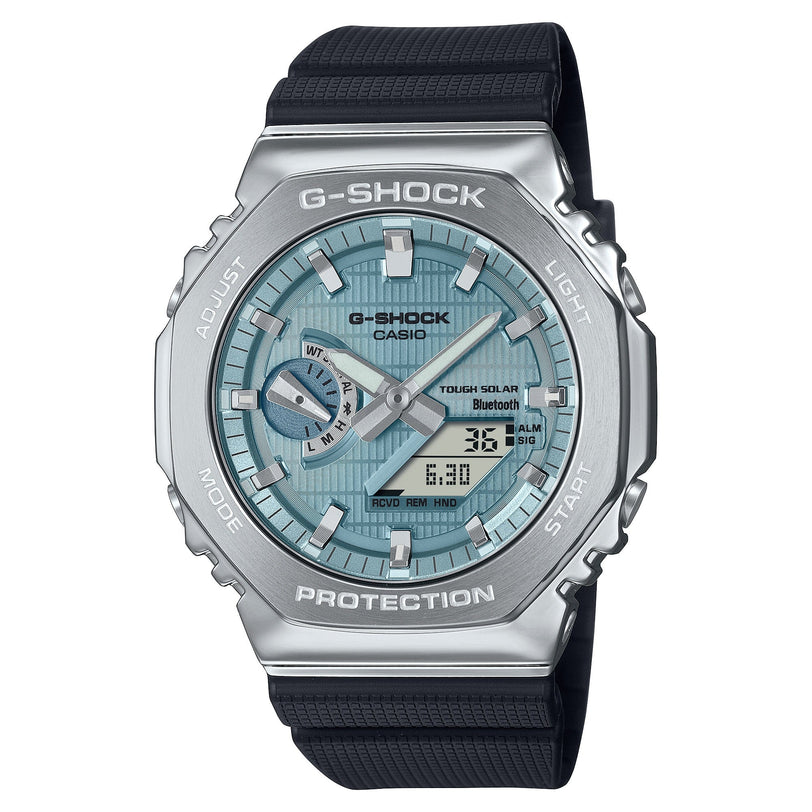 G-SHOCK digital watch with silver stainless steel case, light blue dial, black resin band, and analog/digital display.