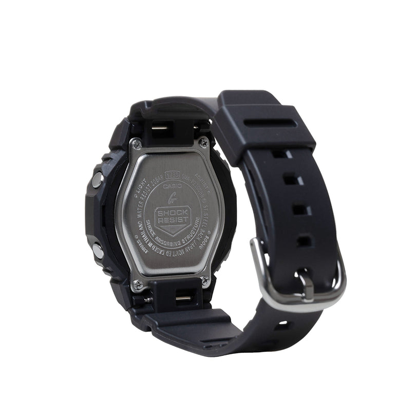 Black resin digital watch with square face, metal case back, and black band with metal buckle.