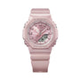 Pink G-Shock watch with square face, analog and digital display, resin band, and protection text on case.