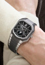 Luxury watch with detailed face on a wrist, brand visible