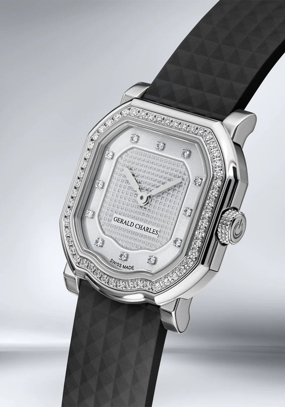 Gerald Charles watch with black strap and diamond-studded face on a light gray background