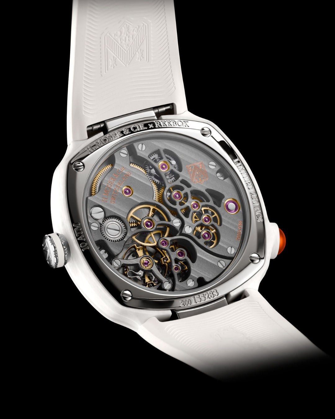 White watch with exposed skeleton movement, gold and silver gears, purple jewels, black metal bezel, and orange accents on cr