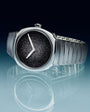 Silver-tone watch with black textured dial, white hands, and segmented metal bracelet band.