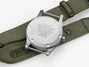 Close-up of a watch with a green strap on a white background