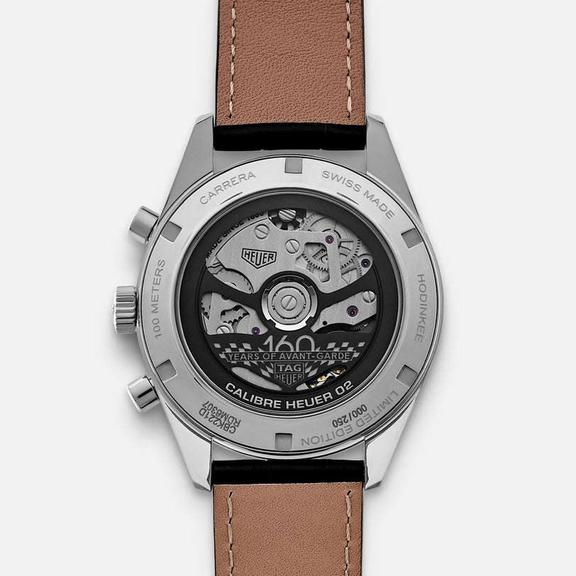 Back view of the TAG Heuer Carrera Dato Limited Edition For HODINKEE, showing its mechanical movement and engraved stainless steel case, paired with a brown leather strap.