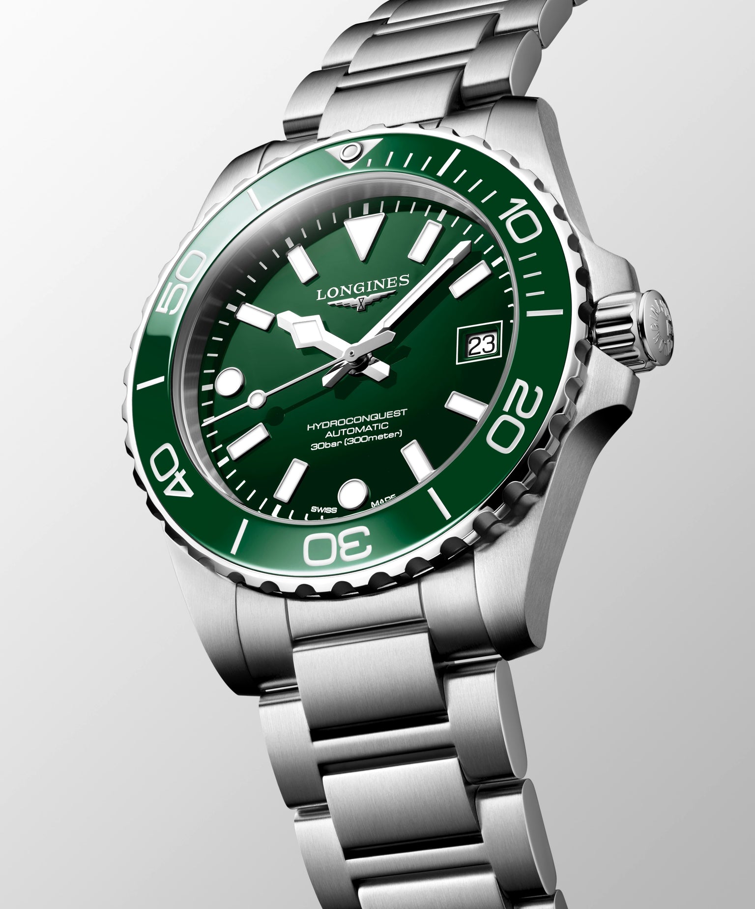 Longines watch with green dial and silver bracelet on a light gray background