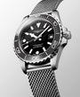 Longines watch with black dial and silver mesh band on a light gray background