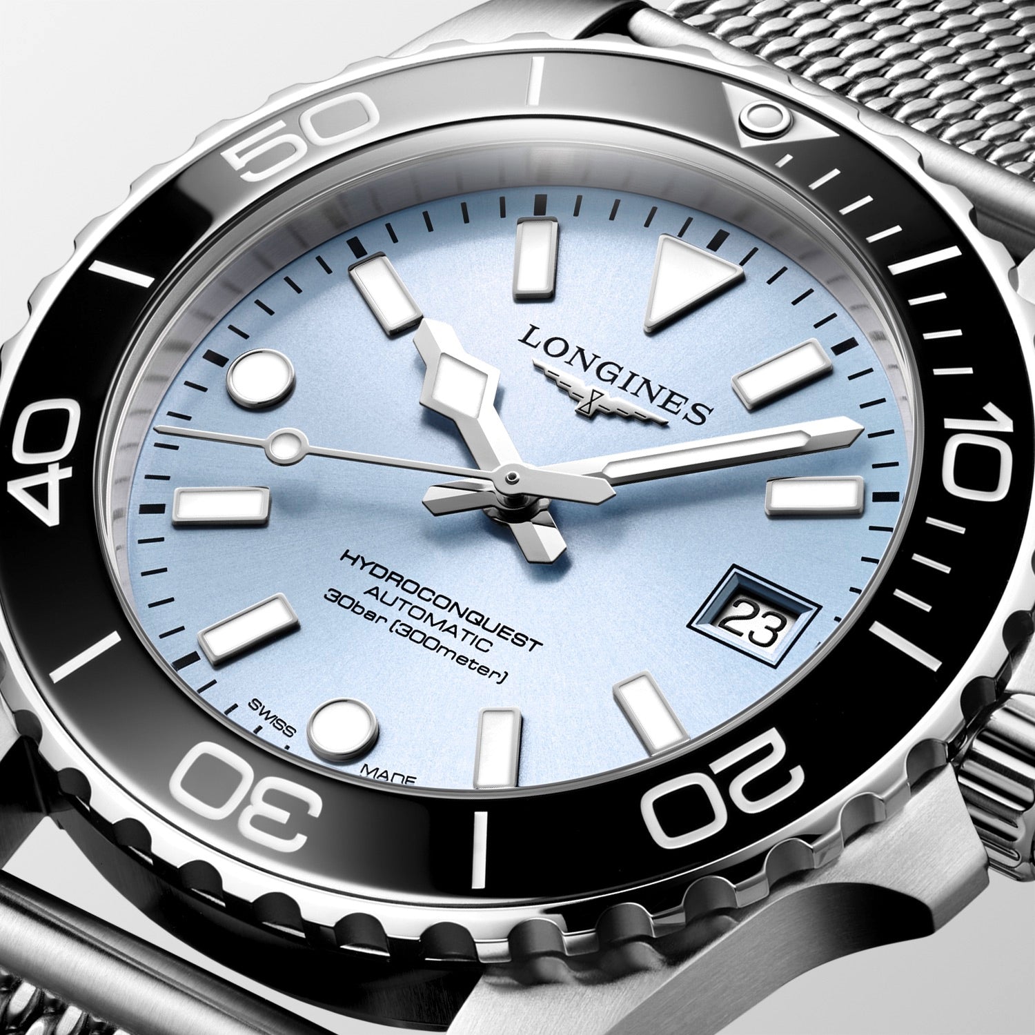 Longines watch with silver bezel and blue dial on a white background