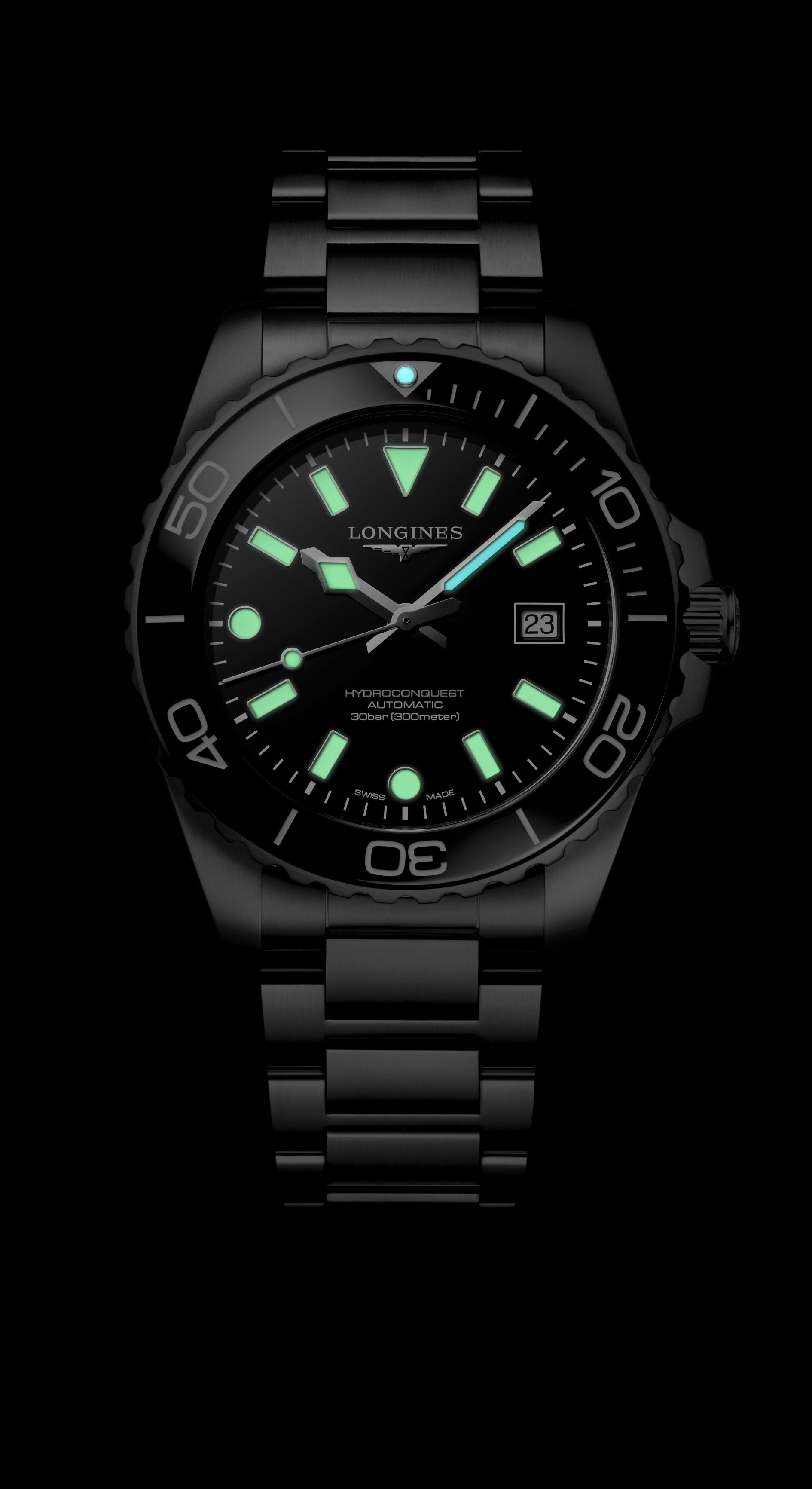 Black wristwatch with glowing green face on a black background