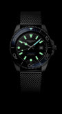 Black wristwatch with glowing face on a black background