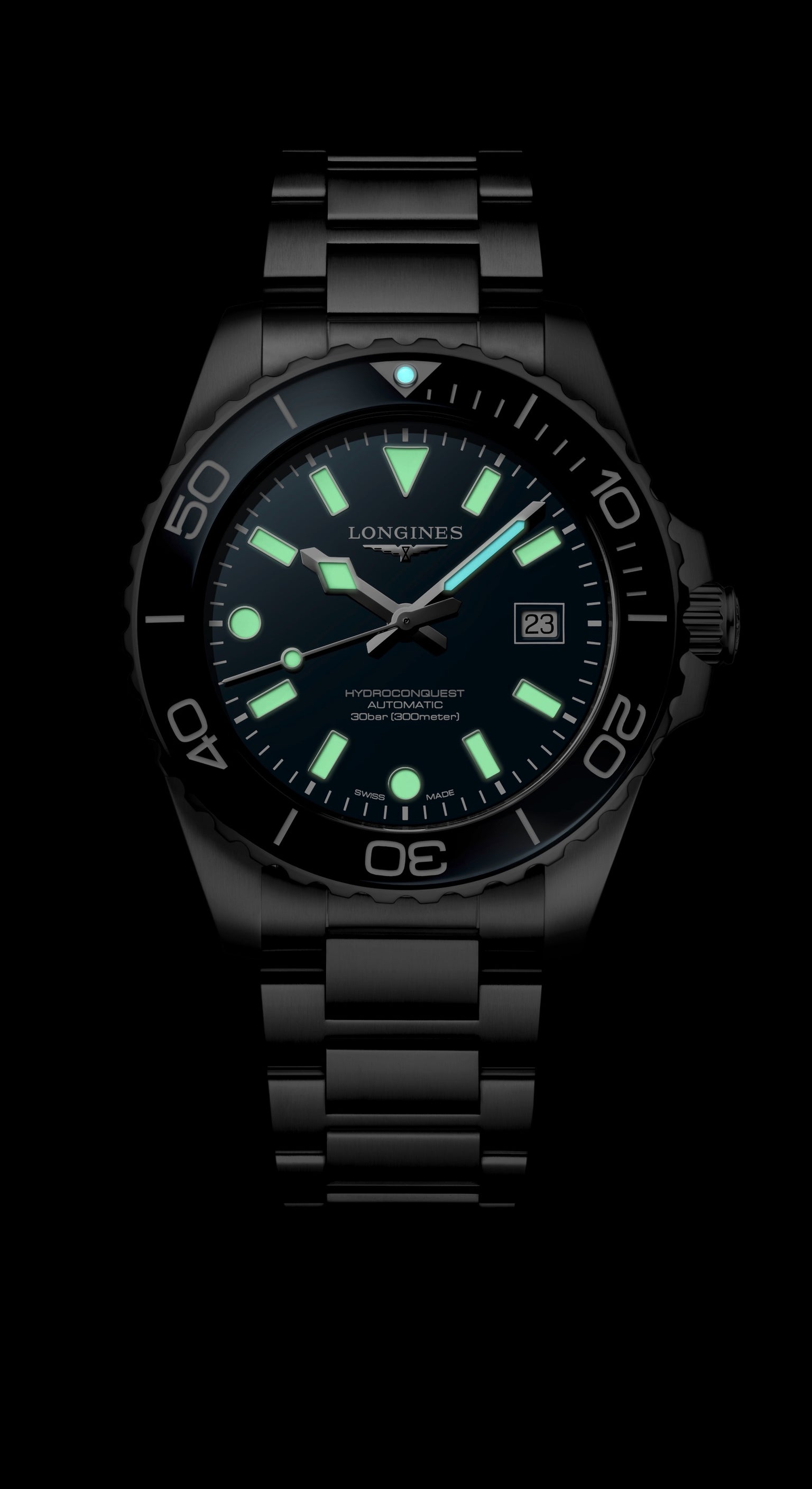 Black wristwatch with glowing green face on a black background