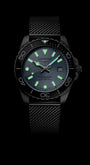 Black wristwatch with glowing face on a black background
