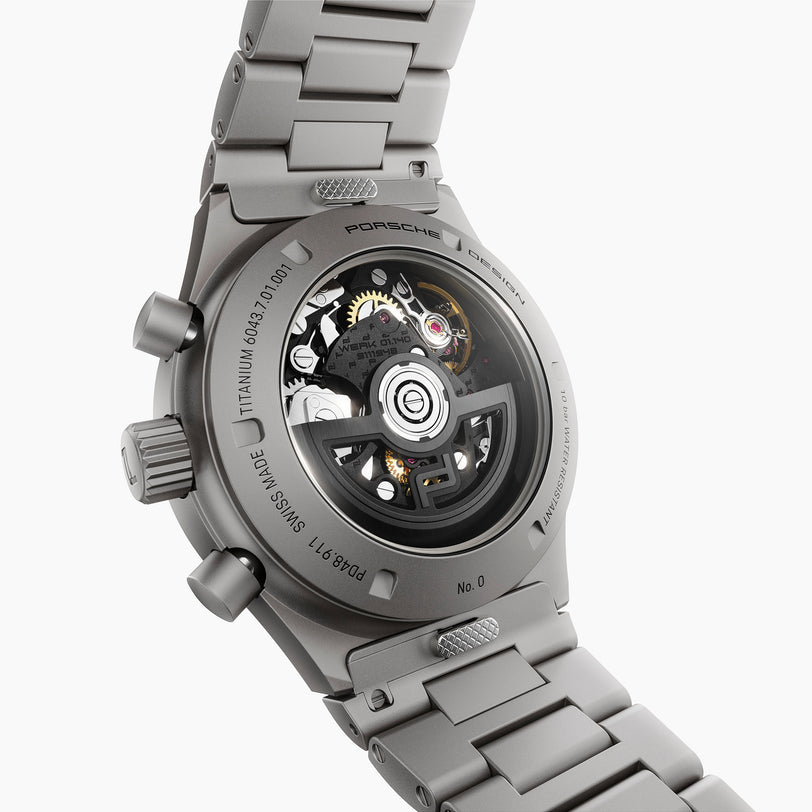Silver Porsche watch with detailed mechanical components on a white background