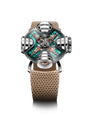 The MB&F HM11 Art Deco is a futuristic wristwatch with a complex mechanical design, tan textured strap, and green metallic face. Its skeletonised dial exposes intricate parts, while cylindrical displays protrude from the Art Deco-inspired case.