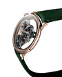 The MB&F SP One Rose Gold is a luxury watch featuring exposed gears, a green leather strap, and a rose gold case, shown on a white background.