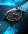 Wristwatch with black dial and blue strap on a blue digital background