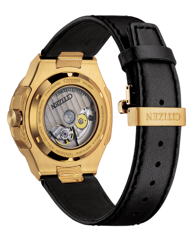 Gold-tone stainless steel watch with black dial and black leather strap, showing exposed movement through transparent casebac