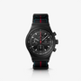 Porsche Design Chronograph 1 75 Years Porsche Edition: black chronograph watch with a black strap, red and blue accents, and tachymeter bezel on a white background.