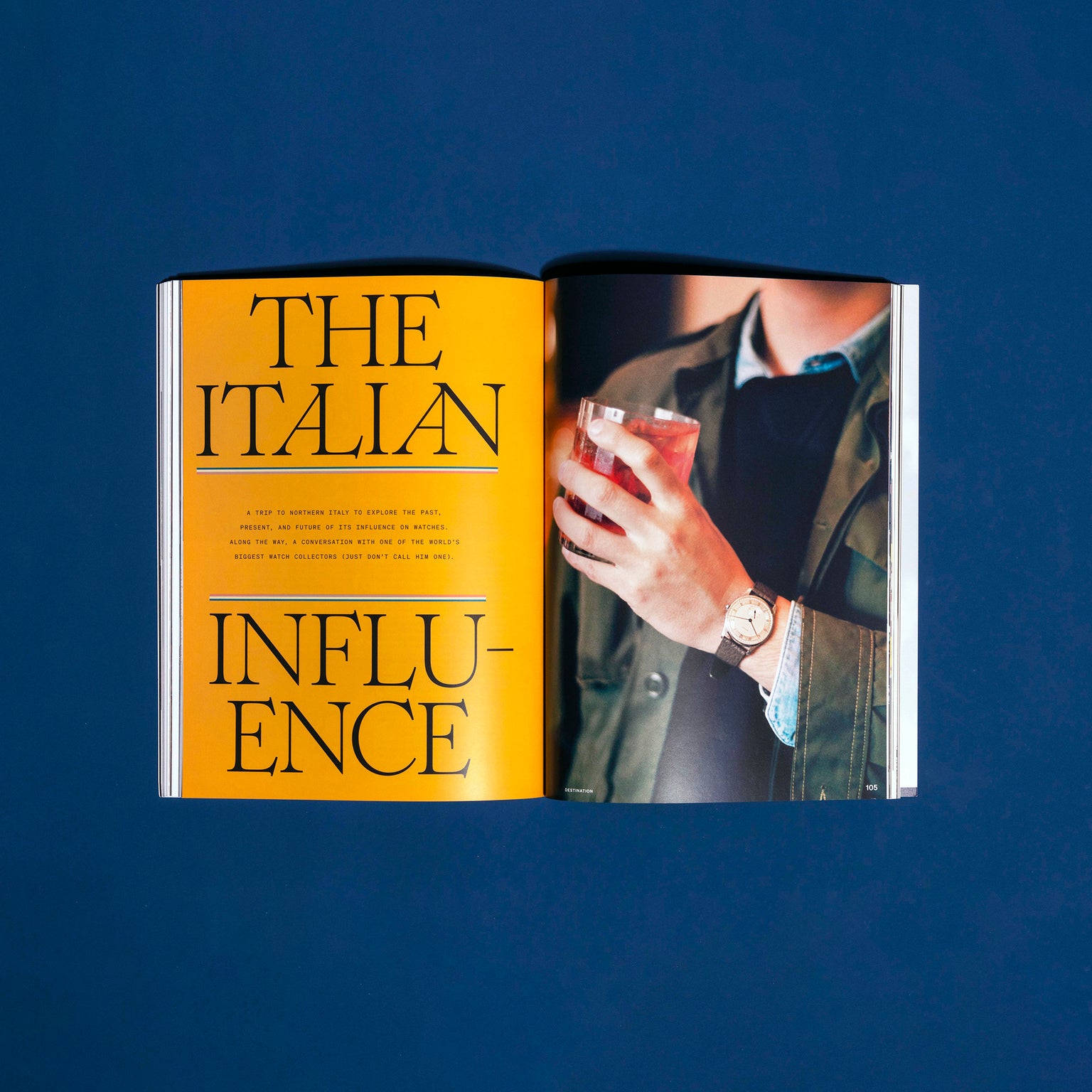 An open HODINKEE Magazine, Volume 12 by Hodinkee reveals a bold yellow “The Italian Influence” page and a photo of someone with a drink, capturing the feel of iconic watch ads on the facing page.
