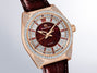 Rose gold watch with deep red dial, diamond-set bezel and lugs, baguette and round stone hour markers, burgundy leather strap