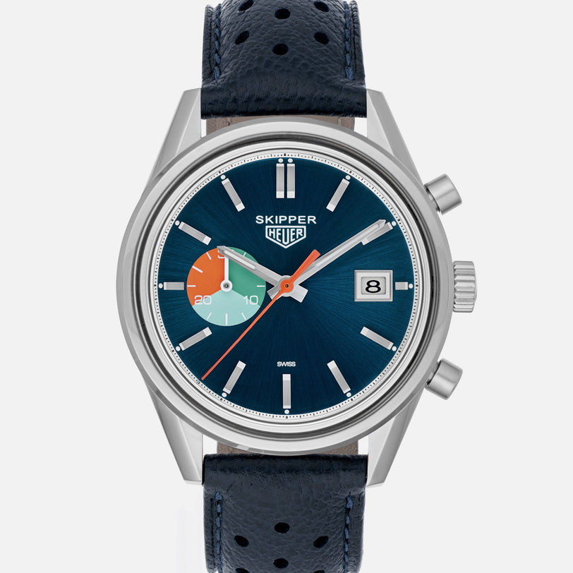 The TAG Heuer Limited Edition Carrera Skipper For HODINKEE features a blue dial, date window, and black perforated leather strap.
